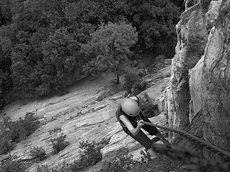 The author rappelling along cliff face in 2008
